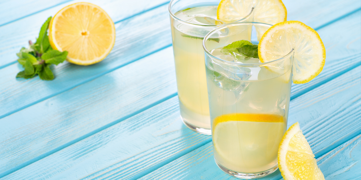 Image of two glasses of lemonade on a blue wood surface